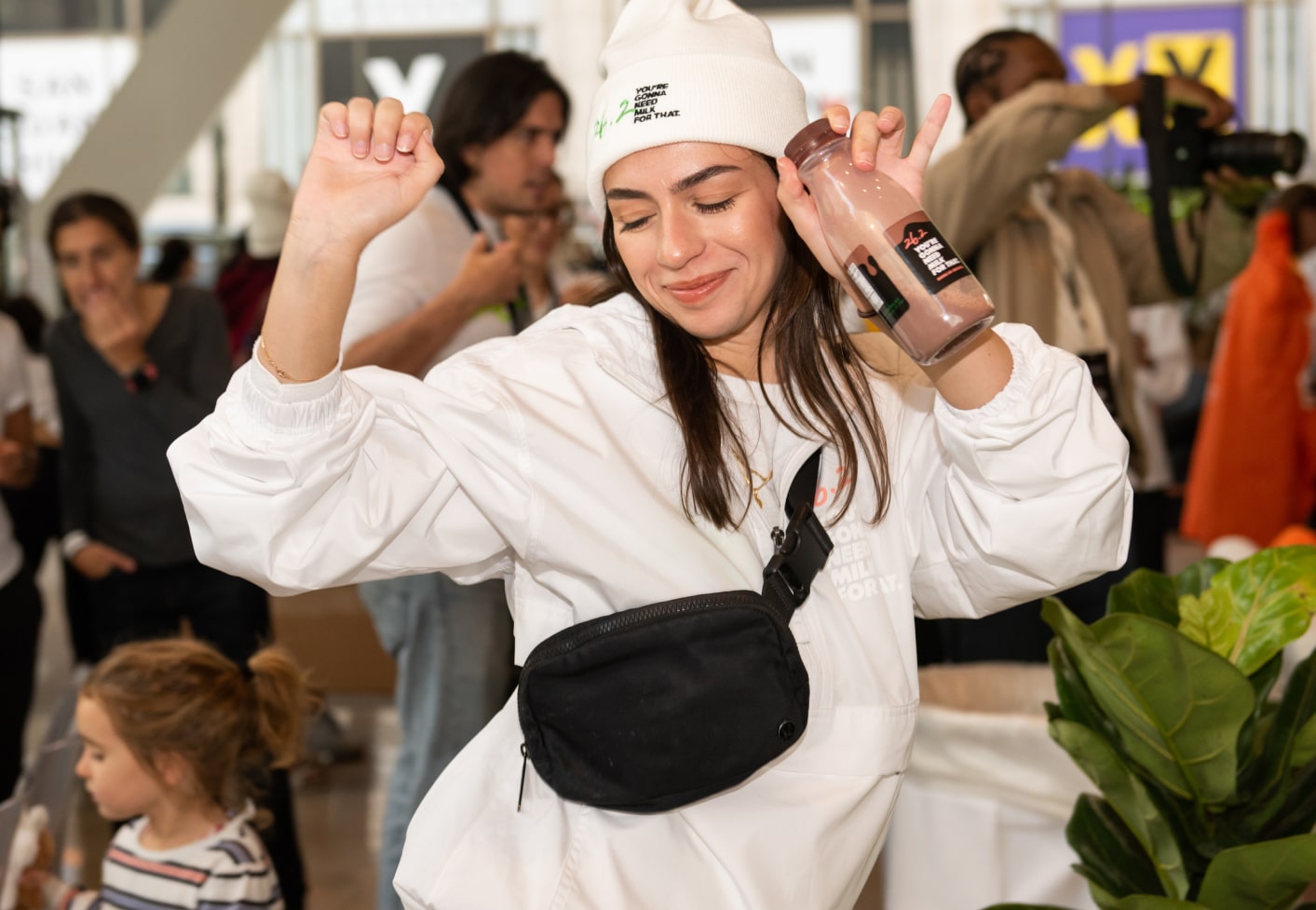 A woman holding up a bottle of 26.2 Chocolate Milk.